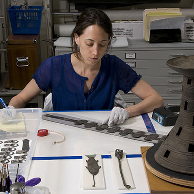 LeeAnn Barnes Gordon adjusting metal pieces on a belt