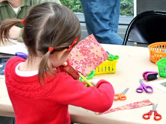 Art in Bloom Community Day Young visitor cutting paper with floral pattern at table