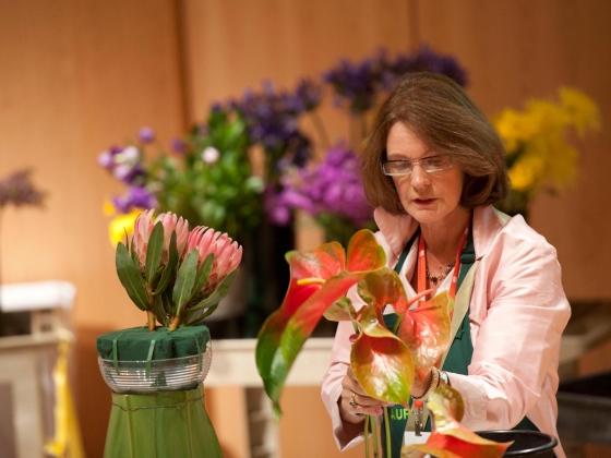 Designing with Flowers event Floral designer giving demonstration of flower arranging