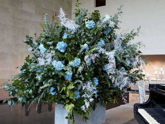 Large floral arrangement by piano in Sackler Wing of Metropolitan Museum of Art